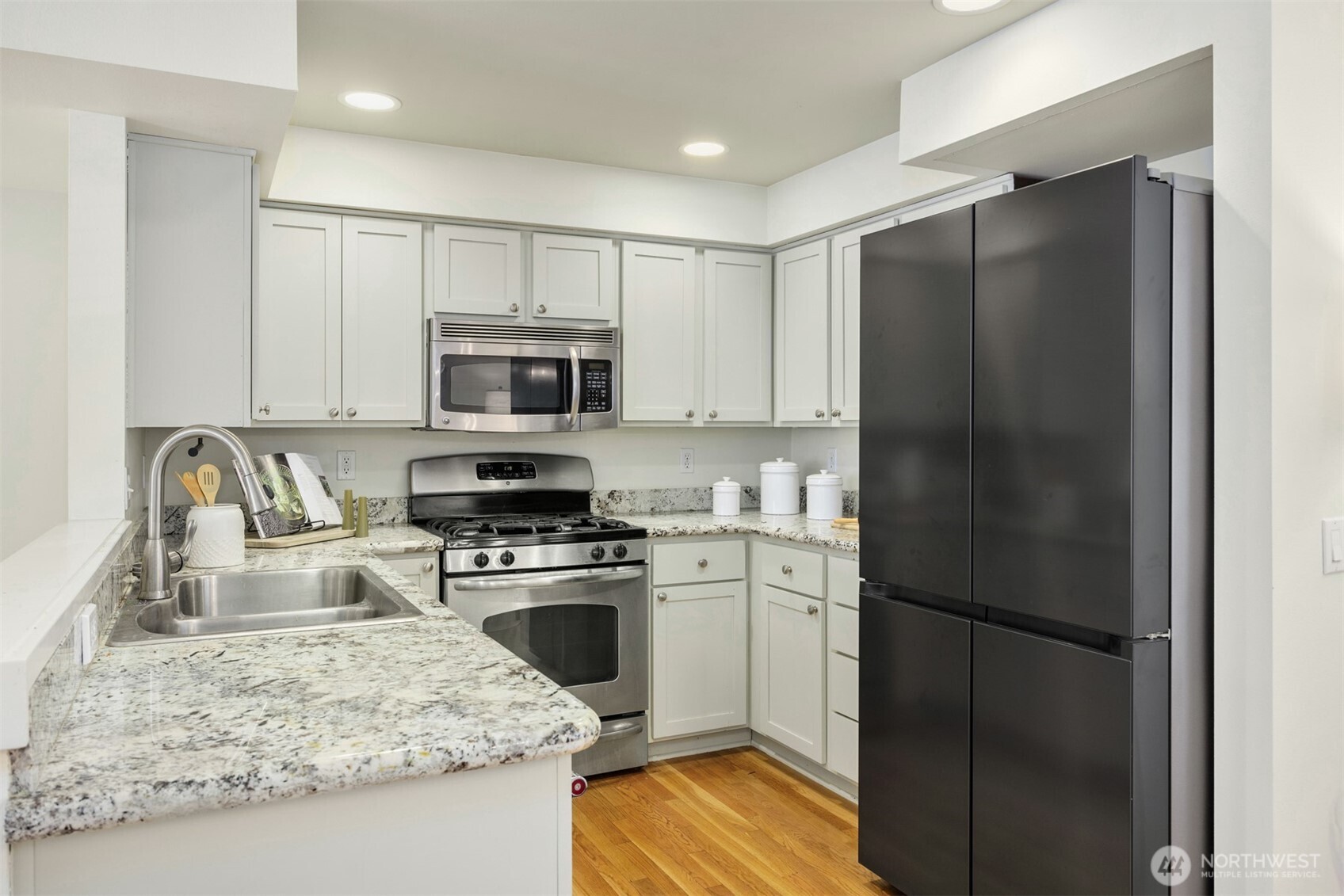 5233 Russell Avenue Northwest, Unit A Seattle, WA 98107 - Photo 3 of 29 a kitchen with a refrigerator stove and microwave