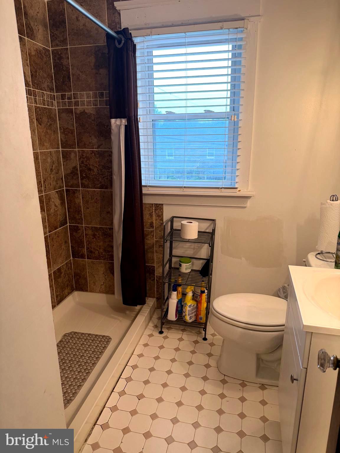 463 Burmont Road Drexel Hill, PA 19026 - Photo 32 of 39 a bathroom with a toilet a window and shower