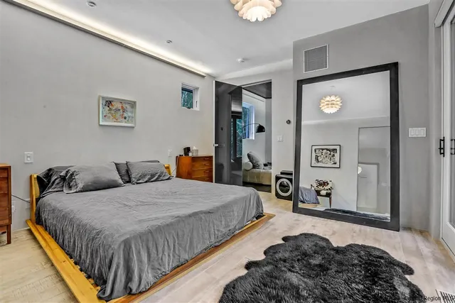 a bedroom with a bed and a large window