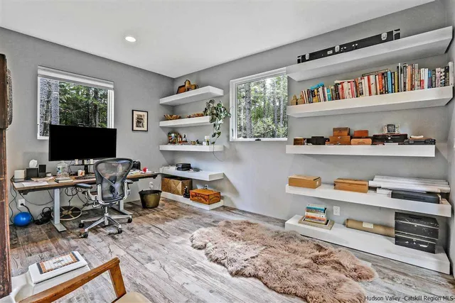 a view of brick house with a patio