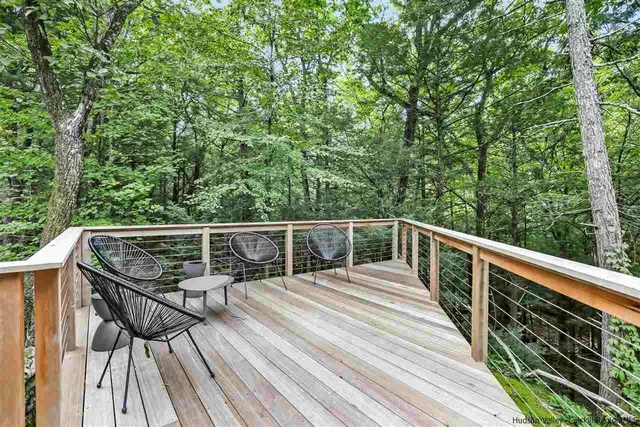 a room with wooden floor pool table and windows