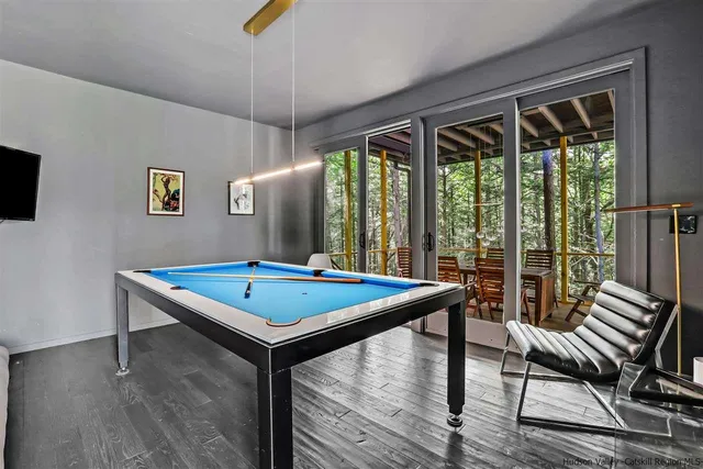 a view of a balcony with chairs and wooden floor