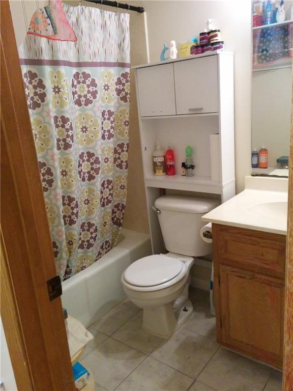 3506 Speedway, Unit 106 Austin, TX 78705 - Photo 5 of 9 Full bathroom with vanity, shower / tub combo with curtain, and light tile patterned flooring