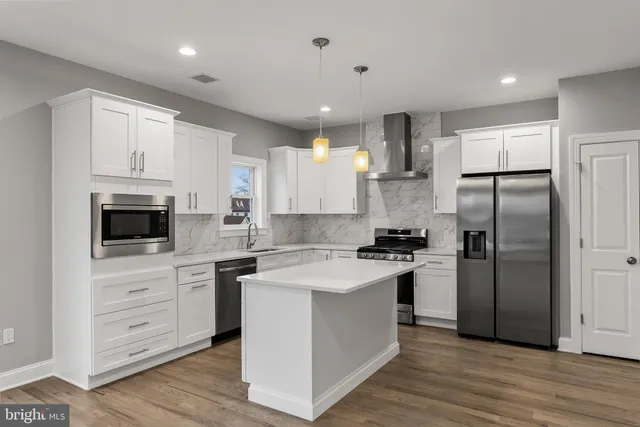 a kitchen with a sink stove and refrigerator