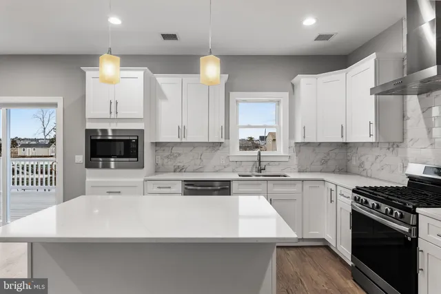 a kitchen with white cabinets and appliances