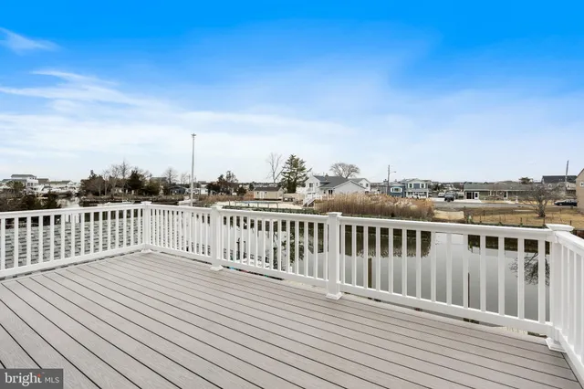 an aerial view of a house with outdoor seating