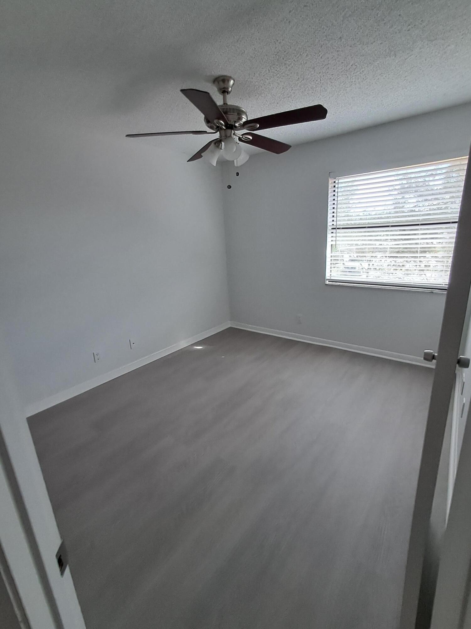12236 Sag Harbor Court, Unit 4 Wellington, FL 33414 - Photo 9 of 11 an empty room with a window