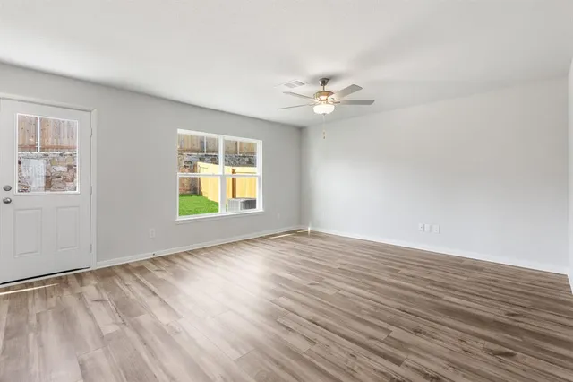wooden floor in an empty room with a window