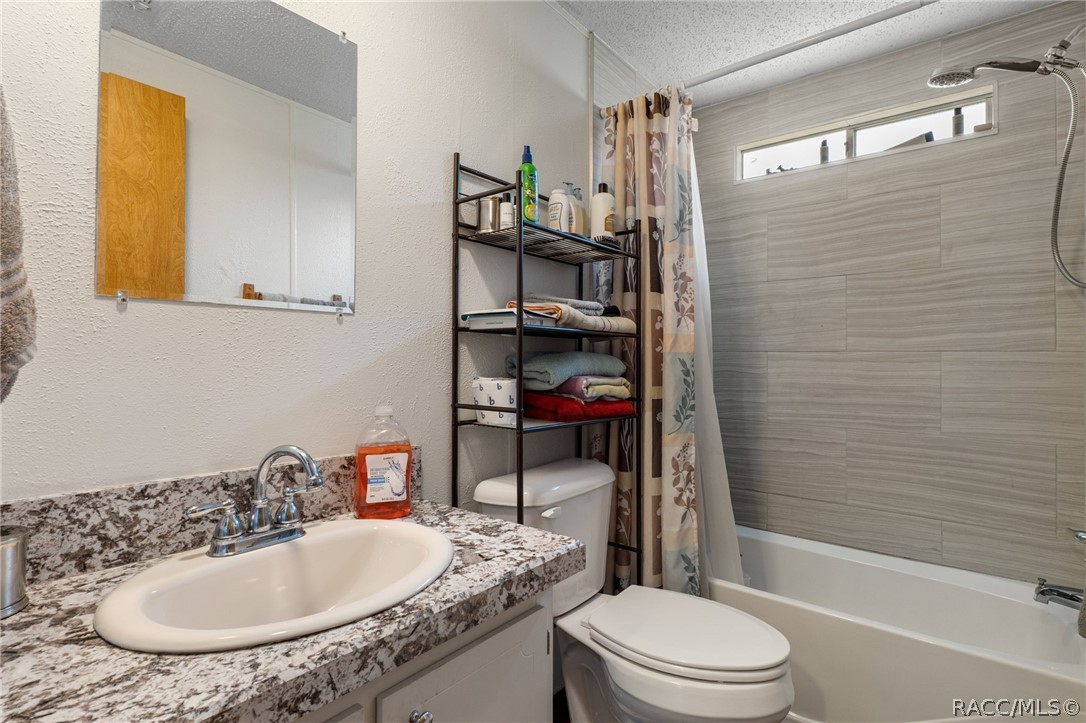 7927 West Cyprian Court Homosassa, FL 34448 - Photo 29 of 40 a bathroom with a sink a toilet and shower