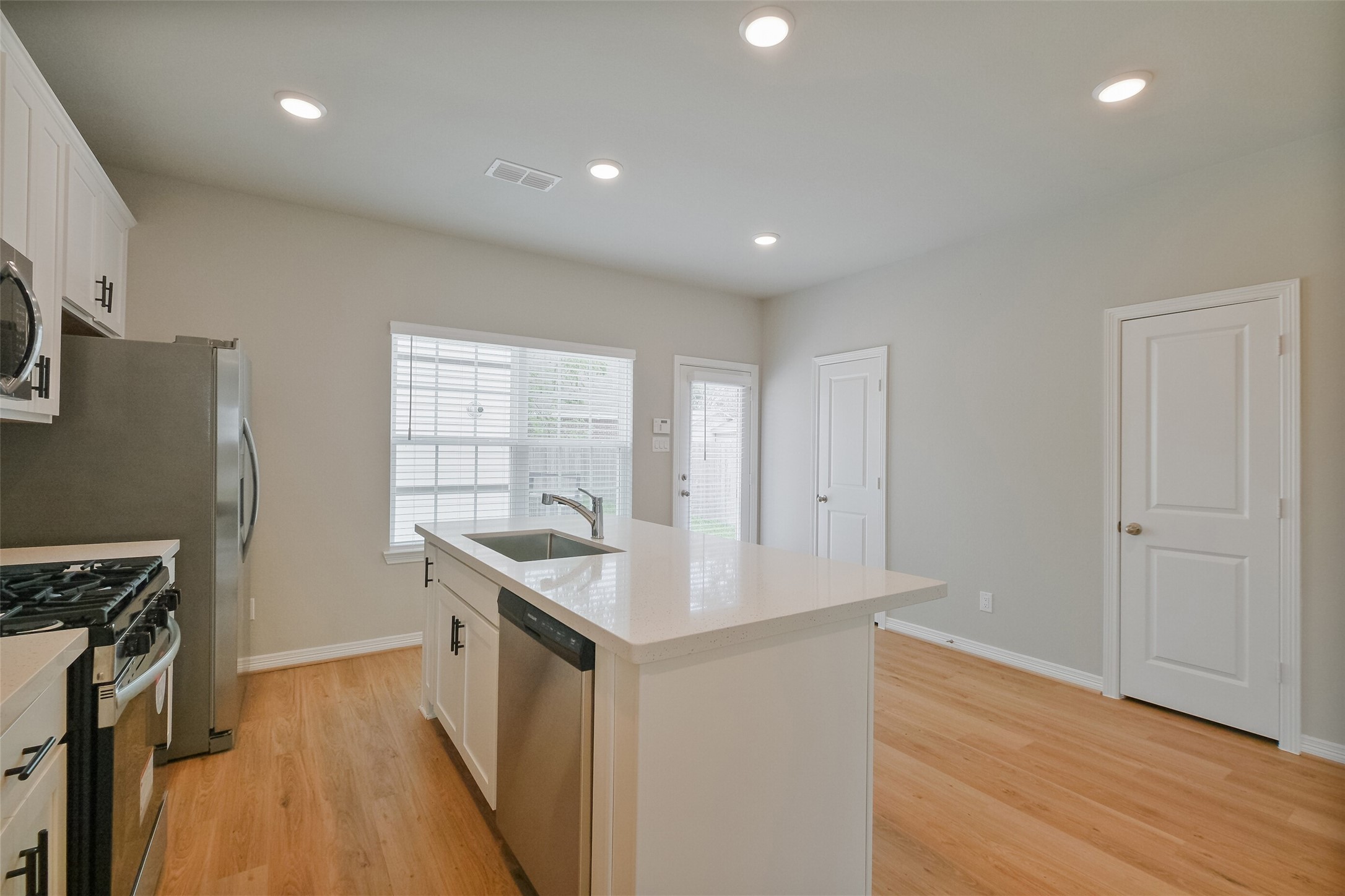 6434 New York Street Houston, TX 77021 - Photo 11 of 26 a kitchen with granite countertop a sink stove and refrigerator
