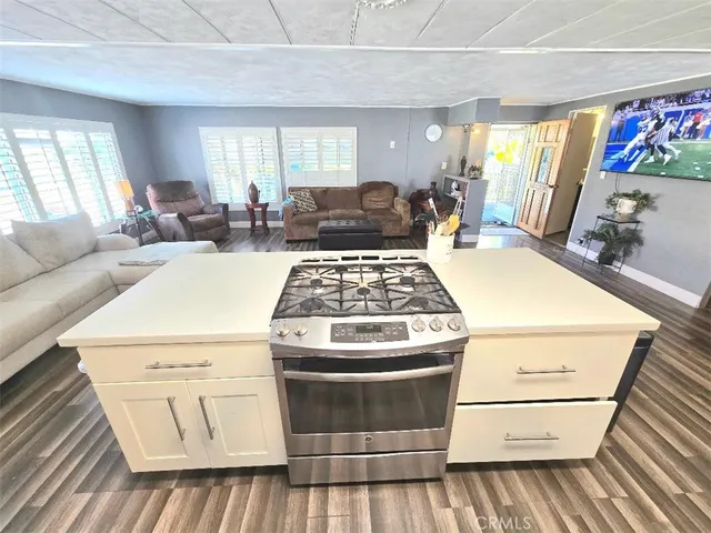 a living room with a stove and a window