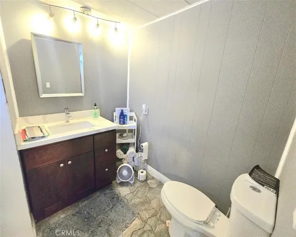 a bathroom with a double vanity sink mirror and toilet