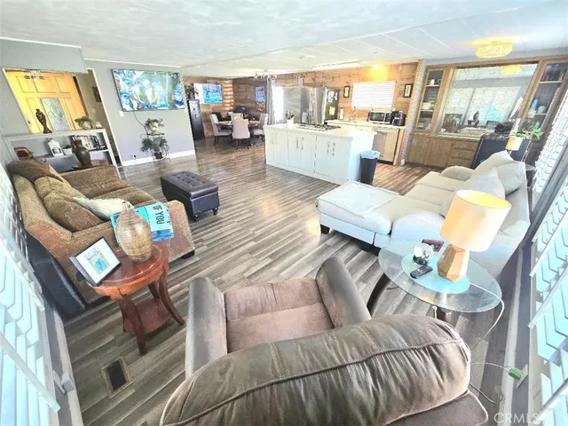 a living room with furniture or wooden floor and a large window