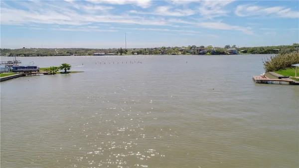 a view of a lake with houses in the back