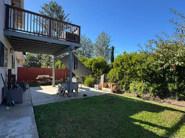 a view of a backyard with sitting area