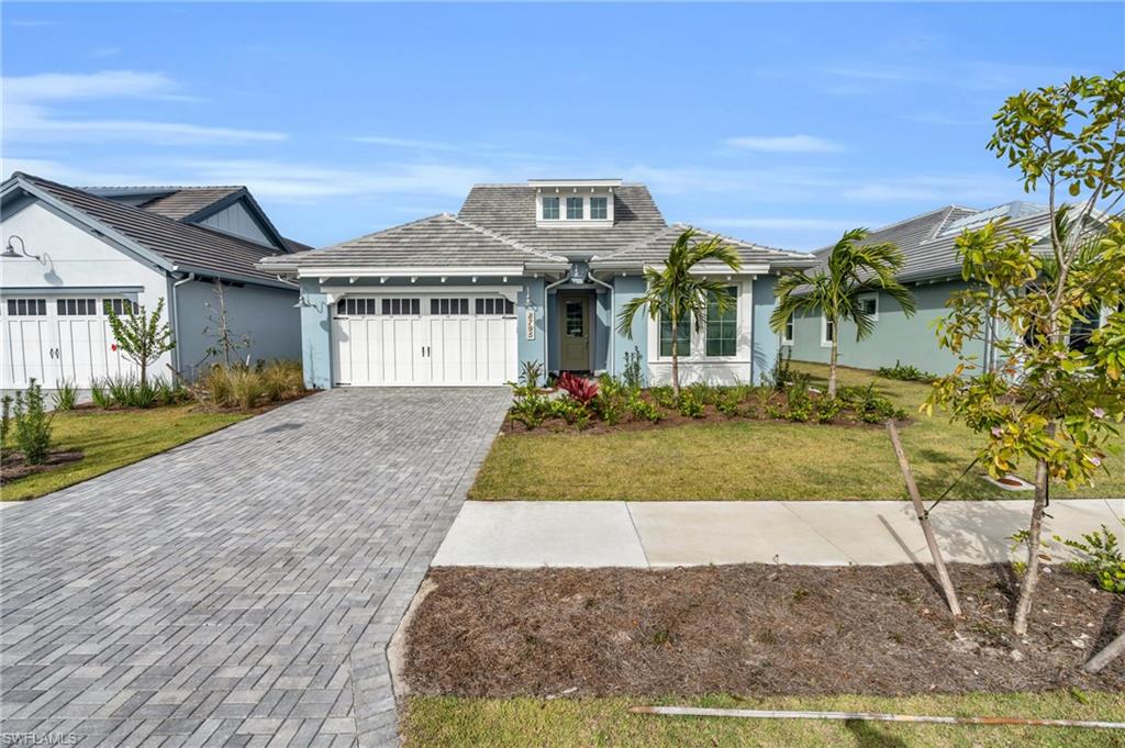8795 Calypso Court Naples, FL 34113 - Photo 3 of 49 a front view of a house with a yard
