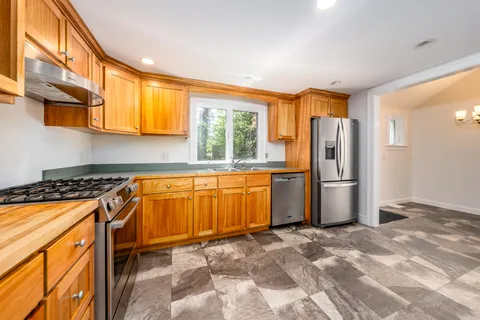 a view of a kitchen with a sink and a window