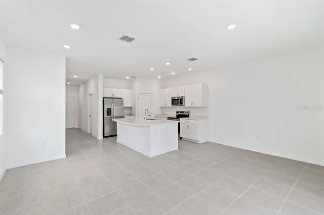 a view of a kitchen with refrigerator and microwave