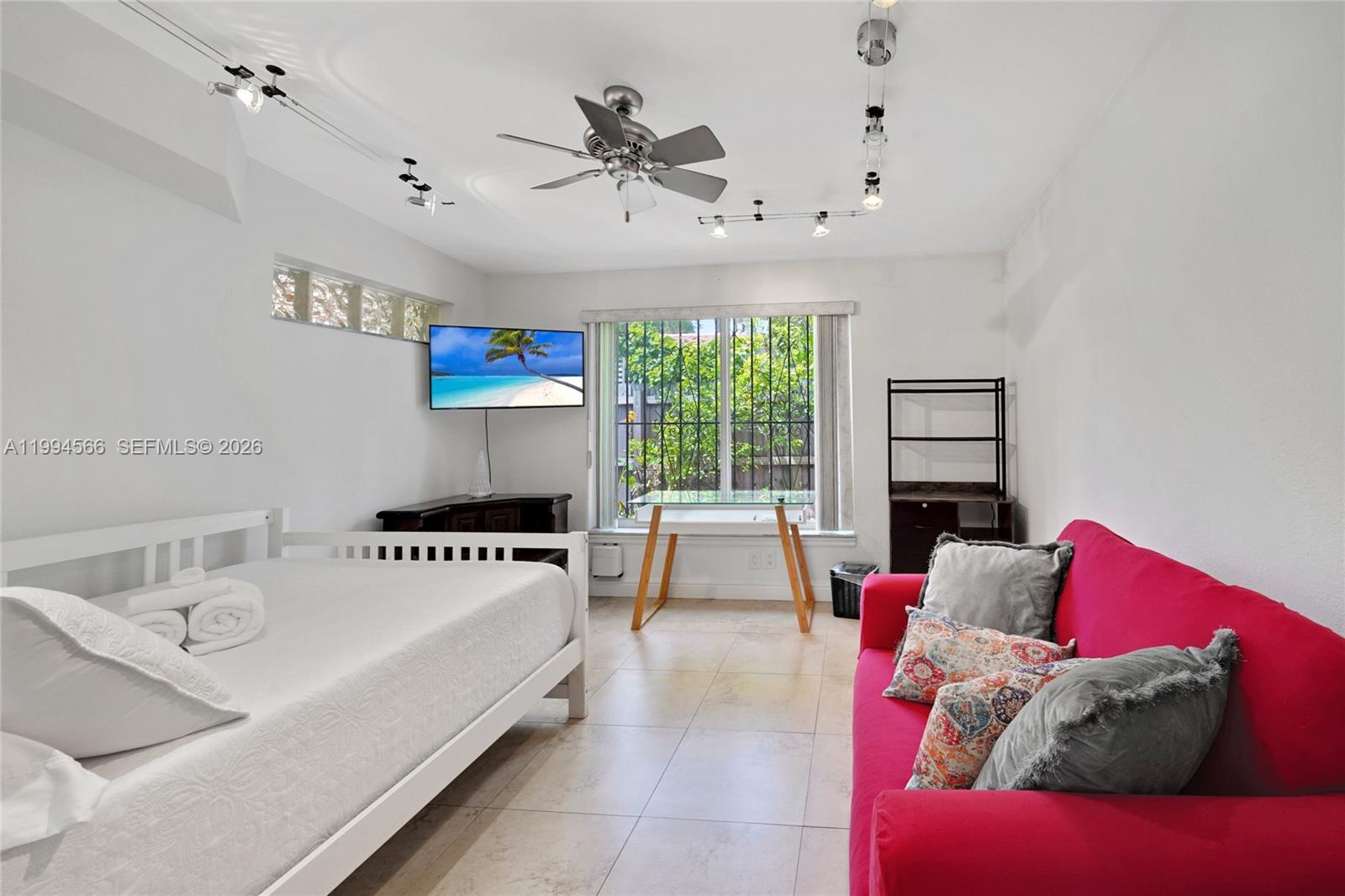 2834 Southwest 33rd Avenue Miami, FL 33133 - Photo 13 of 36 a bedroom with a bed and a couch