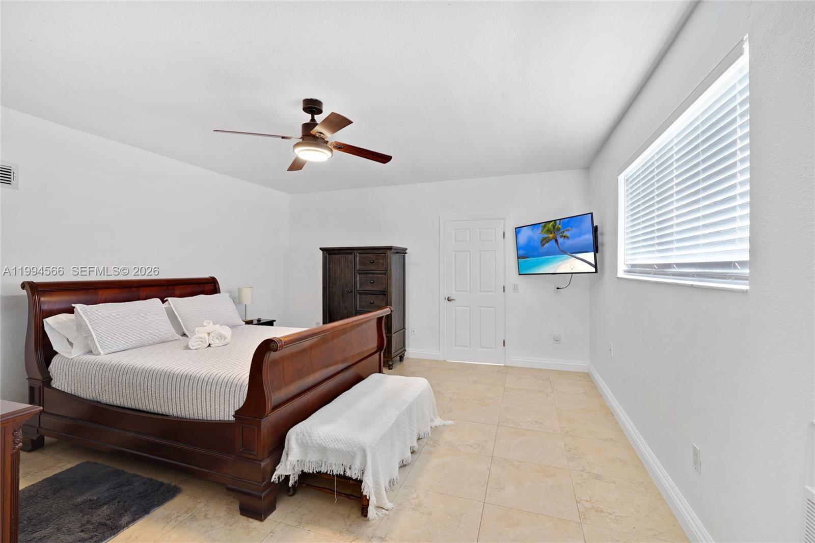 2834 Southwest 33rd Avenue Miami, FL 33133 - Photo 17 of 36 a bedroom with bed and a chandelier