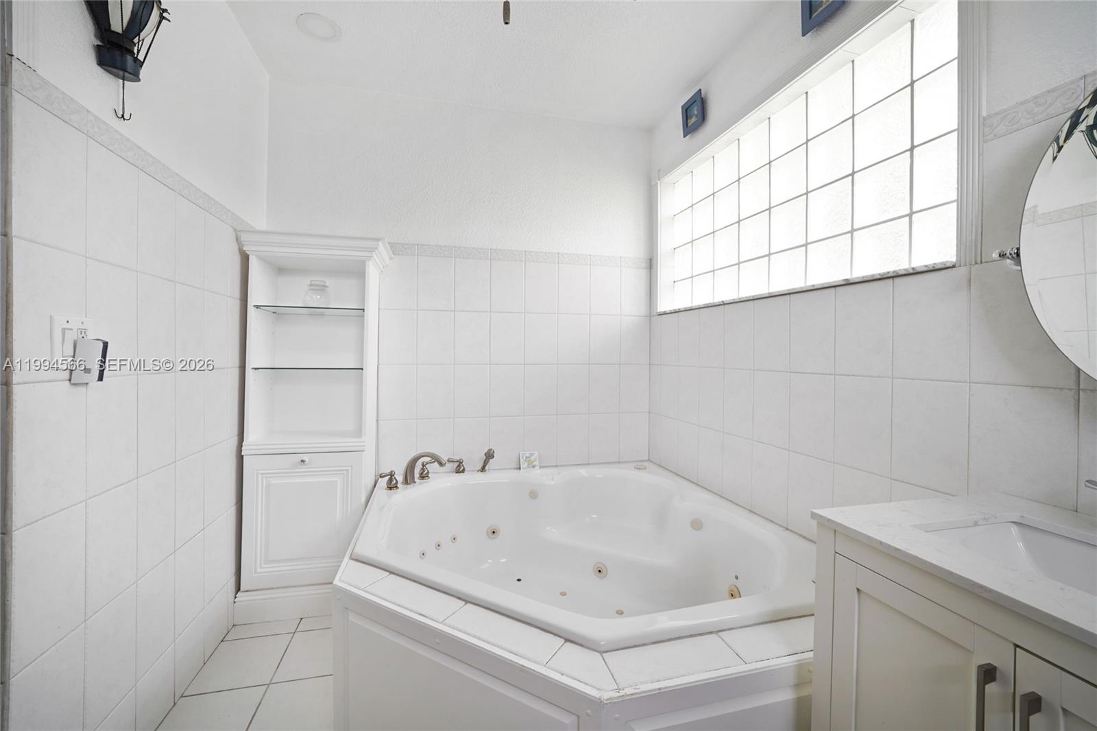 2834 Southwest 33rd Avenue Miami, FL 33133 - Photo 24 of 36 a white bath tub sitting next to a white cabinet