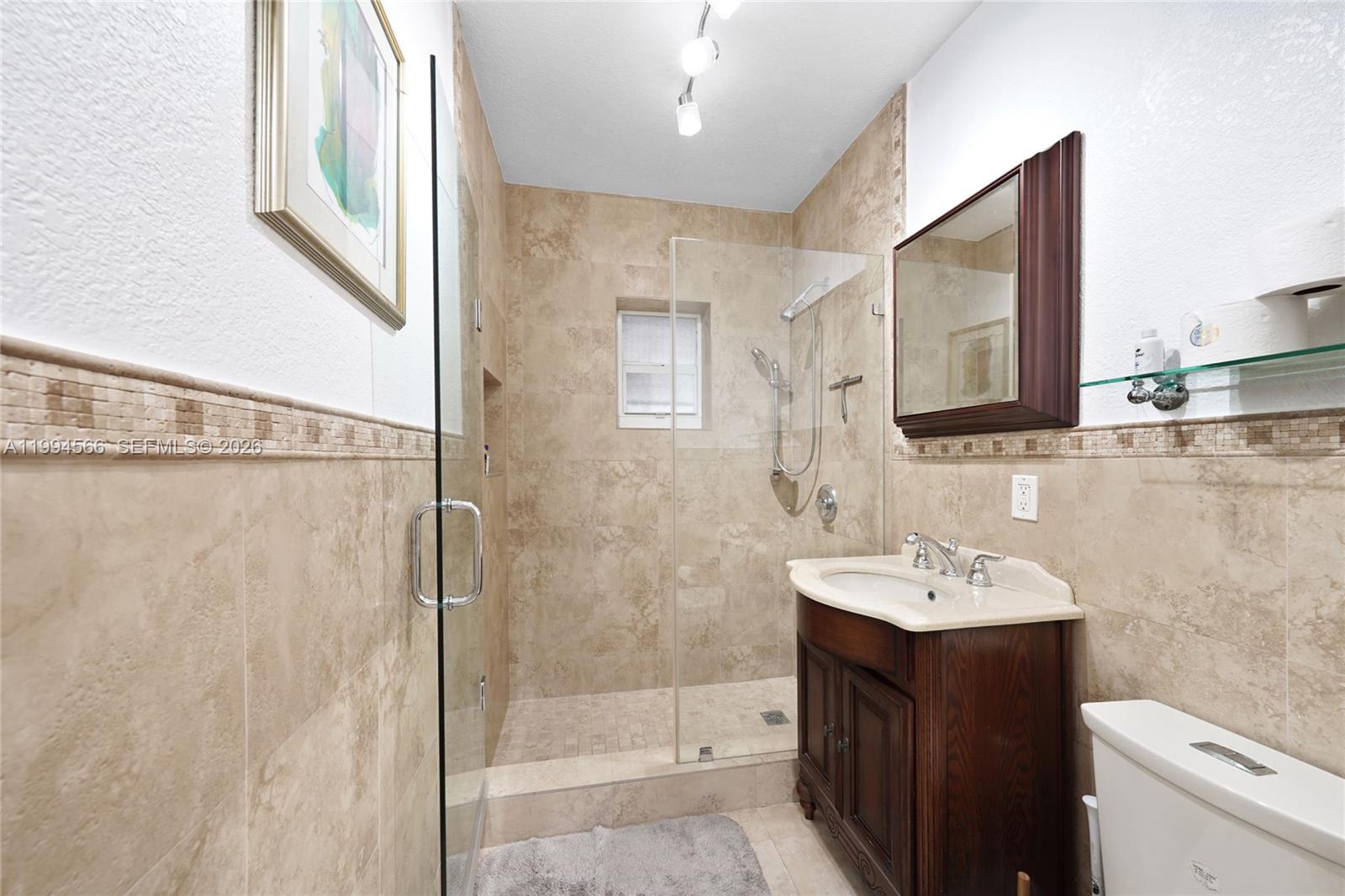 2834 Southwest 33rd Avenue Miami, FL 33133 - Photo 32 of 36 a bathroom with a sink a toilet and shower