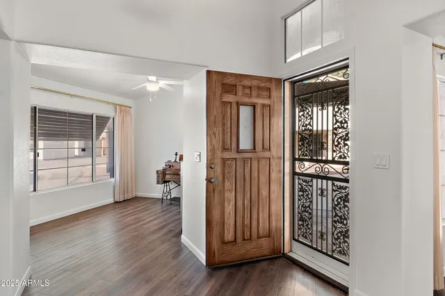 a view of a hallway with wooden floor and dining room