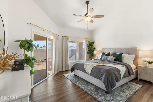 a bedroom with bed and a potted plant