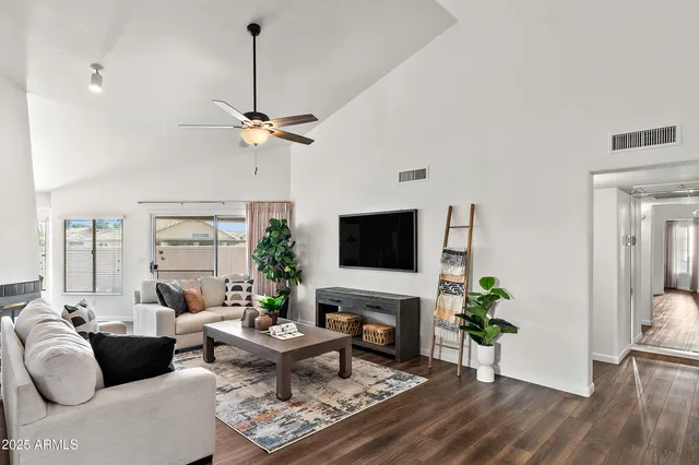 a living room with furniture a fireplace and a flat screen tv