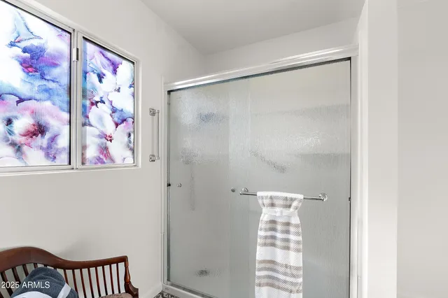 a bathroom with a shower and a curtain