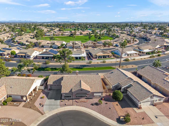 an aerial view of a residential houses with outdoor space