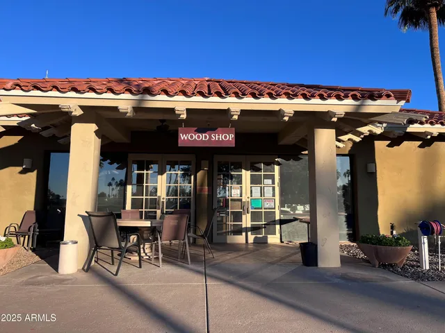 a view of a patio with a table and chairs under an umbrella