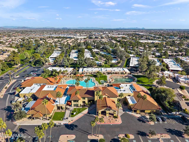 an aerial view of residential houses with outdoor space