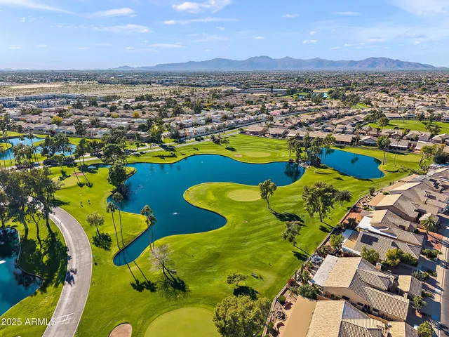 an aerial view of a swimming pool yard and mountain view in back