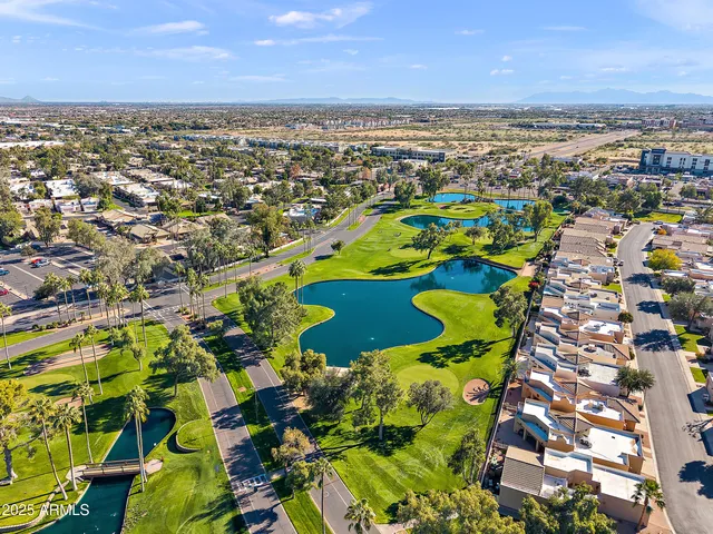 an aerial view of residential houses with outdoor space and swimming pool