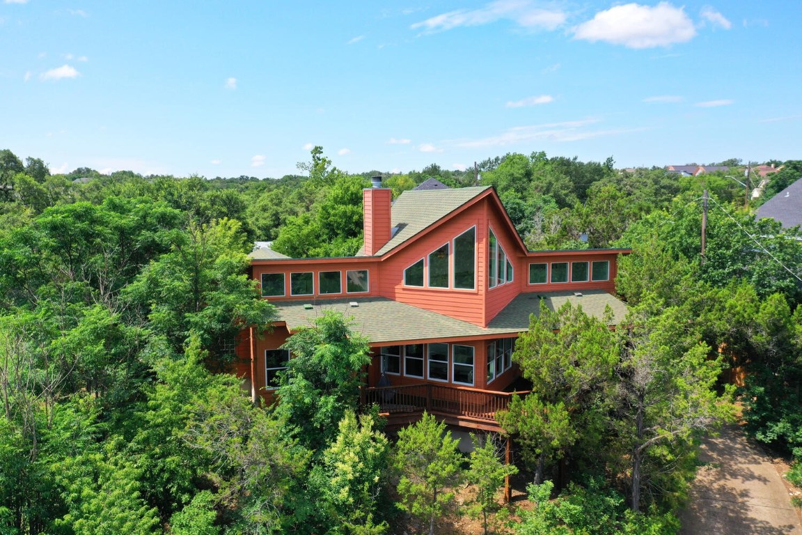 2417 Crazyhorse Pass Austin, TX 78734 - Photo 1 of 1 an aerial view of house with yard and trees in the background