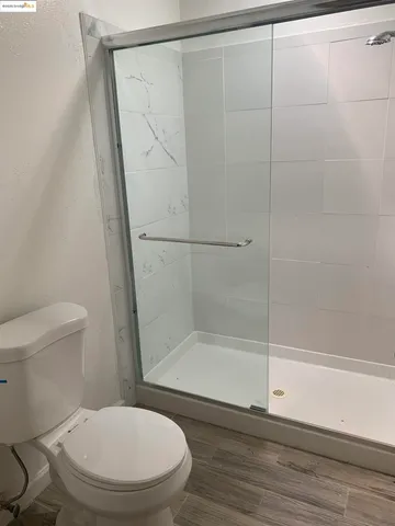 a white toilet sitting next to a bath tub