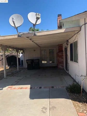 a view of a porch with a table and chairs