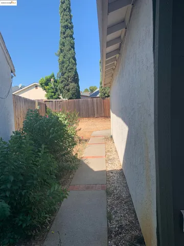a view of a pathway of a house with a yard