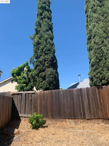 a wooden fence with trees in the background