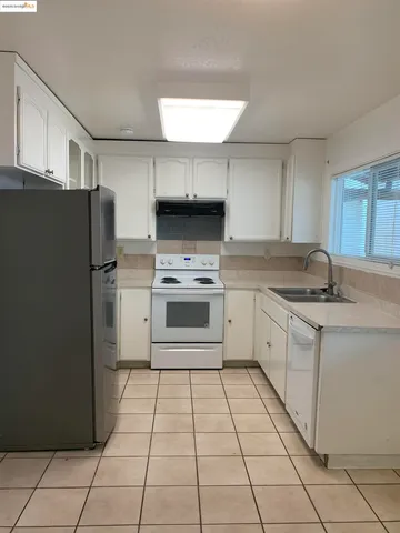 a kitchen with a stove sink and refrigerator