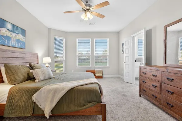 a bedroom with a bed and a dresser