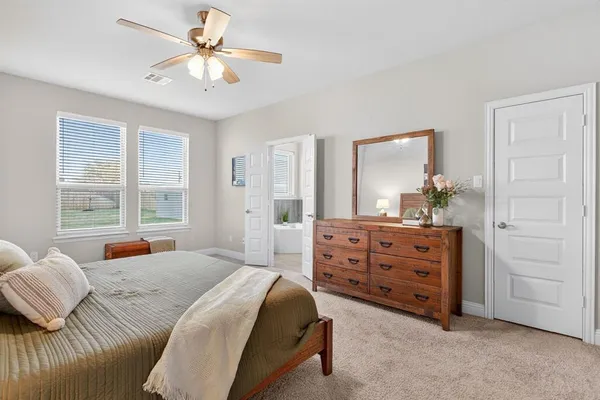 a bedroom with a bed and a dresser