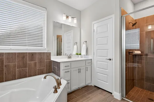 a bathroom with a bathtub and a sink
