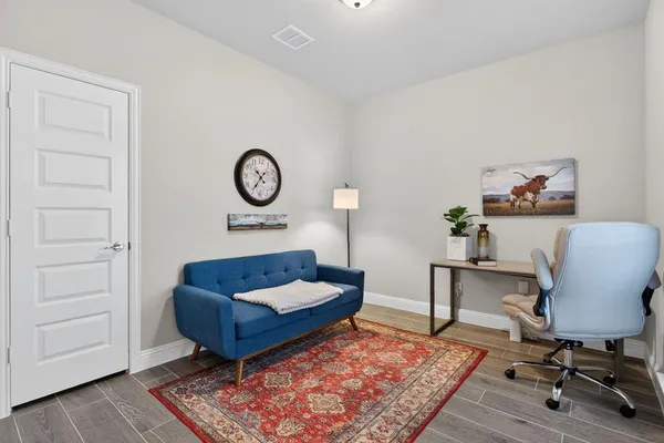 a living room with furniture rug and wooden floor