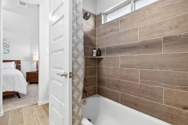 a bathroom with a bathtub and a shower