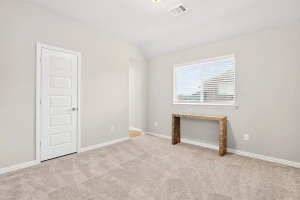 an empty room with windows and closet