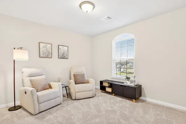 a living room with furniture and a large window