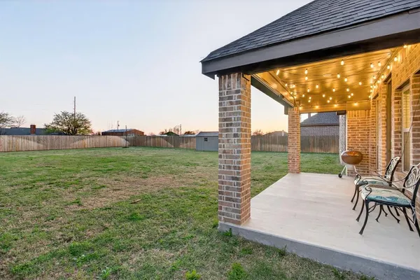 a view of yard with patio
