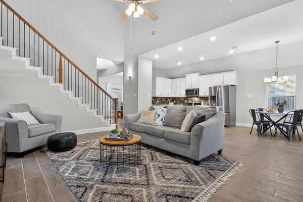 a living room with furniture and kitchen view